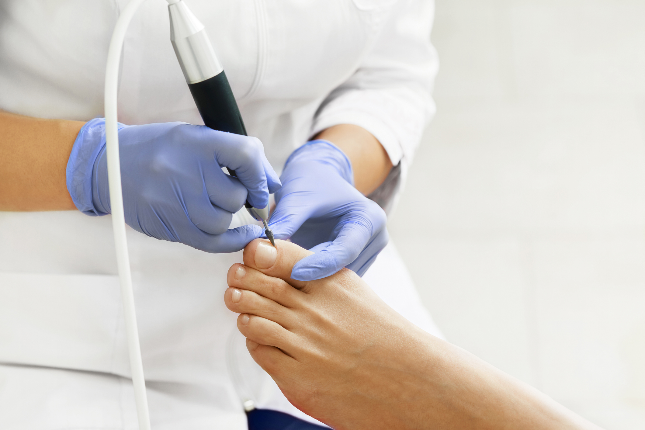 A podiatrist providing foot care to a patient.